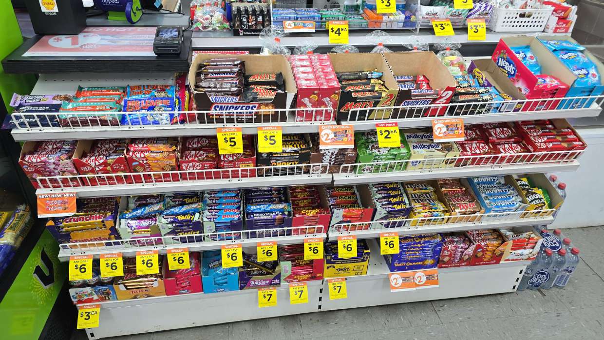 Chips and snack packets on a store shelf